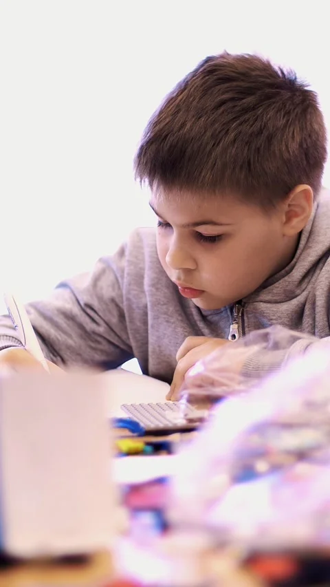 The boy of 10 years, draws a drawing, a project of a robot model, a machine, Stock Footage 314563950