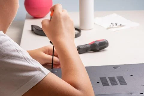 A boy of 10 years old is sorting a laptop for cleaning and maintenance. Selec Stock Photos