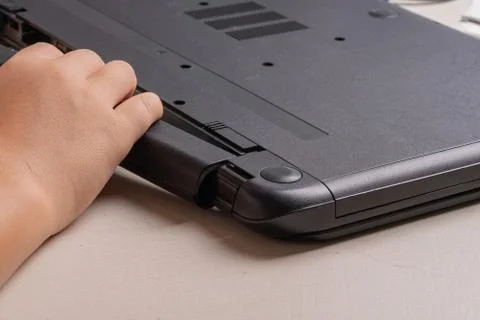 A boy of 10 years old is sorting a laptop for cleaning and maintenance. Selec Stock Photos