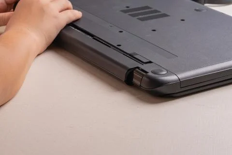 A boy of 10 years old is sorting a laptop for cleaning and maintenance. Selec Stock Photos