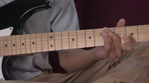 Boy (13-14) playing electric guitar Stock Footage 6471357
