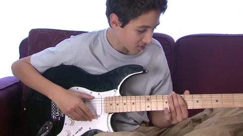 Boy (13-14) playing electric guitar Stock Footage 6472188