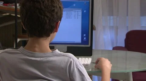 Boy (13-14) working on computer at home, france Stock Footage 6493694