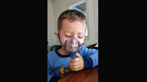 A boy of 3 years is treated with a nebulizer. Stock Footage 160982168