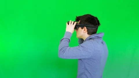 Boy with 3D VR glasses turns on itself, with green screen Stock Footage 61257090