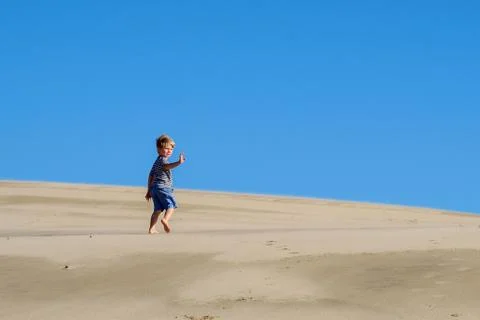 Boy ( 4-5 ) running on beach Stock Photos