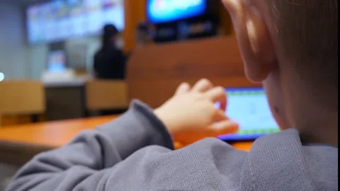 A boy of 4-5 years old plays an educational game on his phone Stock Footage 287945496