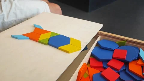A boy of 4 years old plays with a mosaic, collects a picture from small plastic  Stock Footage 281342065