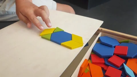 A boy of 4 years old plays with a mosaic, collects a picture from small plastic  Stock Footage 281344531