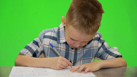 Boy 5 years old writes in a notebook Stock Footage 170694413