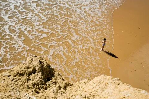 Boy (6-7) on beach, elevated view Stock Photos