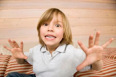 Boy (8-9) making faces, portrait Stock Photos