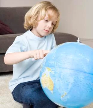 Boy (8-9) pointing at globe, portrait Stock Photos