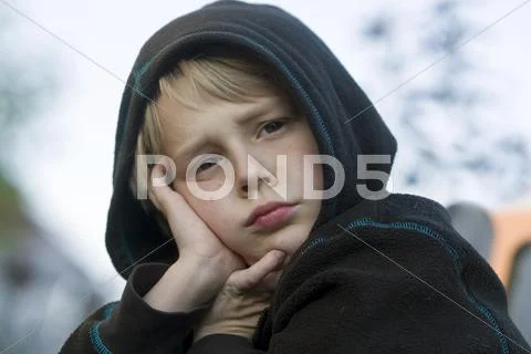 Boy 8 wearing a hood and looking bored Crailsheim Hohenlohe Baden Wurttemberg Stock Photos