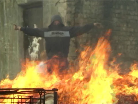 Boy acting like shooting behind a bonfire Stock Footage 77270219