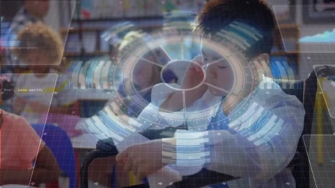 Boy adjusting paper, rubbing temple, class AR rings overlaying paper and laptop Stock Footage 328469078