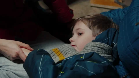 A boy with adults hiding in the cellar Video stock 171534739