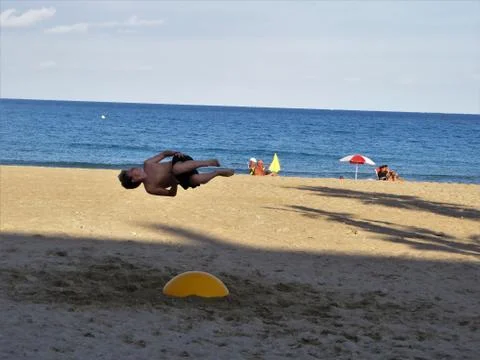 Boy in the air on the beach Stock Photos
