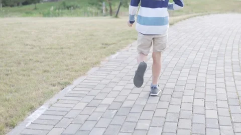 Boy albino blond is running through the park. Stock Footage 110994472