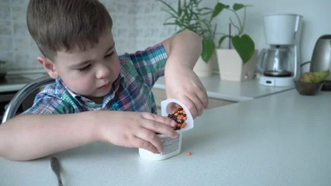 The boy is alone in the kitchen at the table Stock Footage 167590841