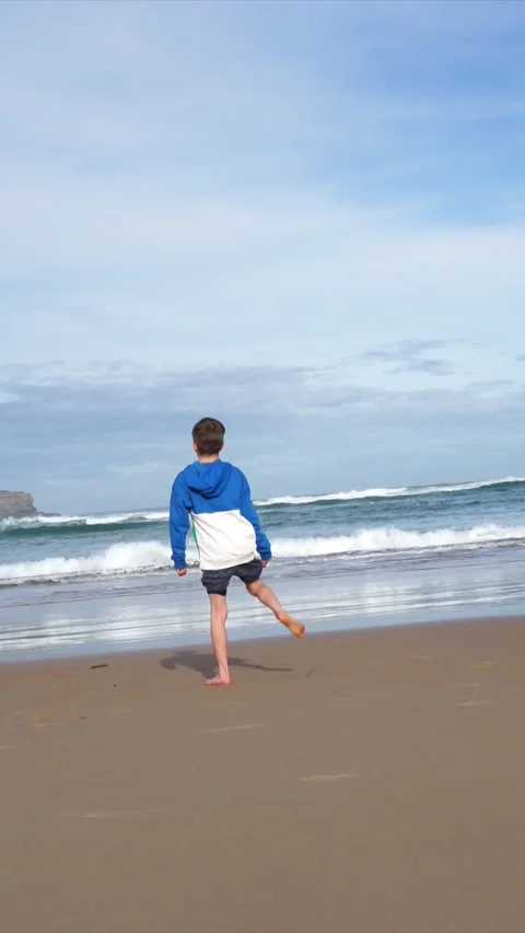 Boy alone on the seashore Stock Footage 260798580