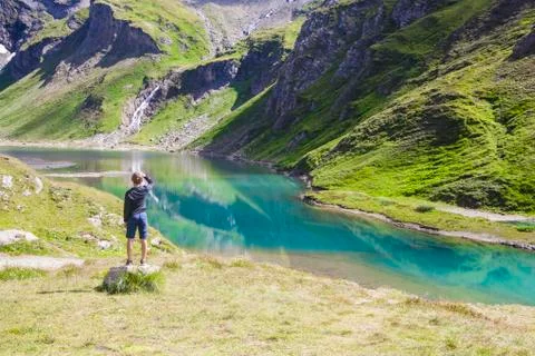 A boy at the alpine lake Stock Photos