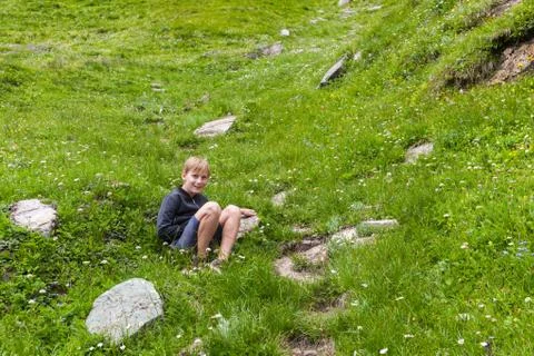 A boy on an alpine meadow Stock Photos