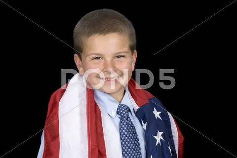 Boy with american flag around shoulders Stock Photos