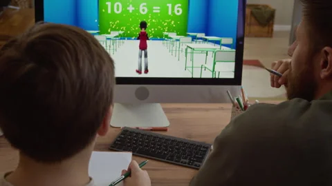 Boy and Father Solving Math Exercise on Computer in Game at Home Stock Footage 332777272