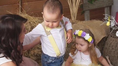 Boy and Girl on a Beautiful Easter Background and the Boy's Mother Stock Footage 74087102