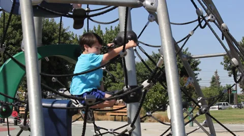 Boy and Girl Climb and Play on Jungle Gym Stock Footage