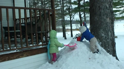 Boy and girl conquer snow bank Video stock 44156927