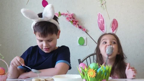 Boy and girl  cookies for easter, laughing.  Easter egg hunt. Stockbeeldmateriaal 150903083