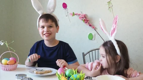 Boy and girl  cookies for easter, laughing.  Easter egg hunt. Stock Footage 150903794