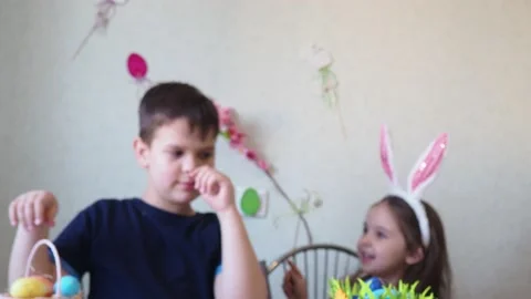 Boy and girl  cookies for easter, laughing.  Easter egg hunt. Stock Footage 150904477