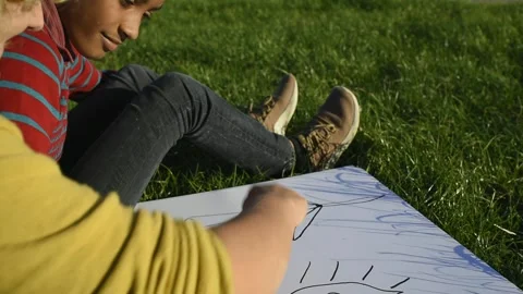 Boy and girl drawing a plan for renewable energy Stock Footage 288118475