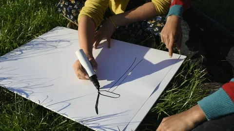 Boy and girl drawing a windmill Stock Footage 288118370