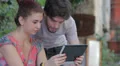 a boy and a girl having fun using a tablet computer HD Footage