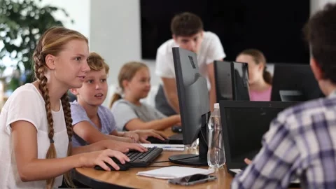 Boy and girl learning to work on computer in classroom Stock Footage 332638429