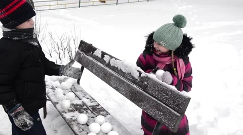 Boy and girl playing snowballs in winter Stock Footage 59115992