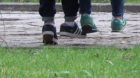 Boy and girl sitting on a bench and talking down. Stock Footage 54184853