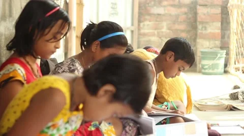 Boy and girl students diligently study in a village school in Bengal, India. Stock Footage