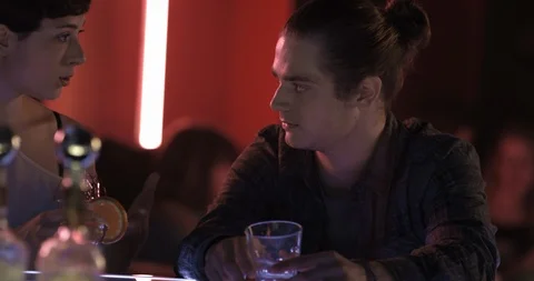 Boy And Girl Talking While Having Drink In Disco Bar 스톡 동영상 108902602