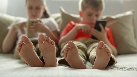 Boy and girl using app on smart phone.  Stock Footage 77691252