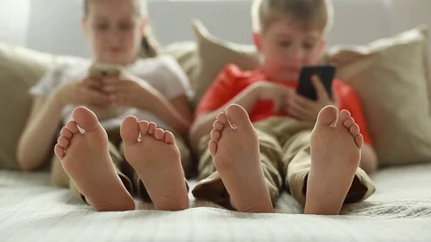 Boy and girl using app on smart phone.  Stock Footage 77691274