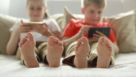 Boy and girl using app on smart phone. Children using smartphone.  Stock Footage 77691346