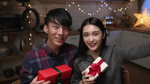Boy and girlfriend showing present box to lens Stock Footage 165756477