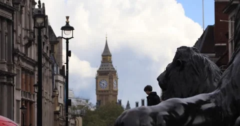Boy and lion statue with Big Ben in London background Video stock 321019518