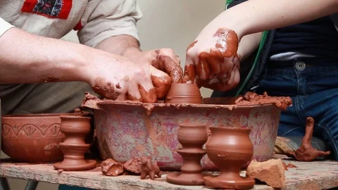 Boy and man making clay pot Stock Footage 120161432