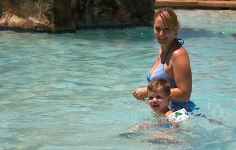 Boy and mom in the pool Stock Photos